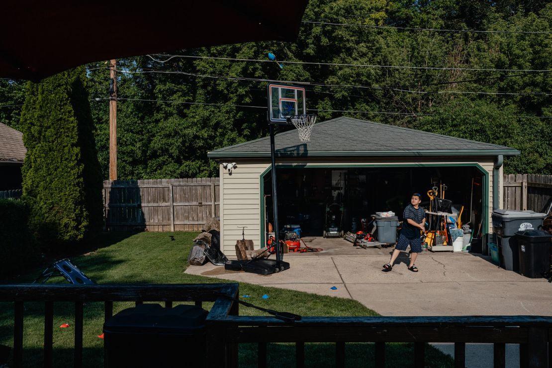 Eleven-year-old Michael Bub III plays in the backyard of his grandparents’ home during a family barbecue.
