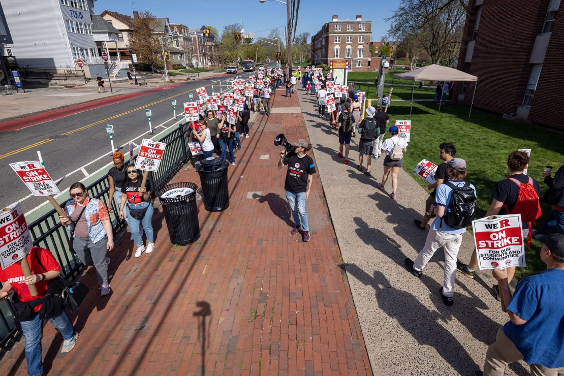 A protester with a bullhorn leads Rutgers students and faculty as they participate in a strike at the university's main campus in New Brunswick, New Jersey, in April 2023.
