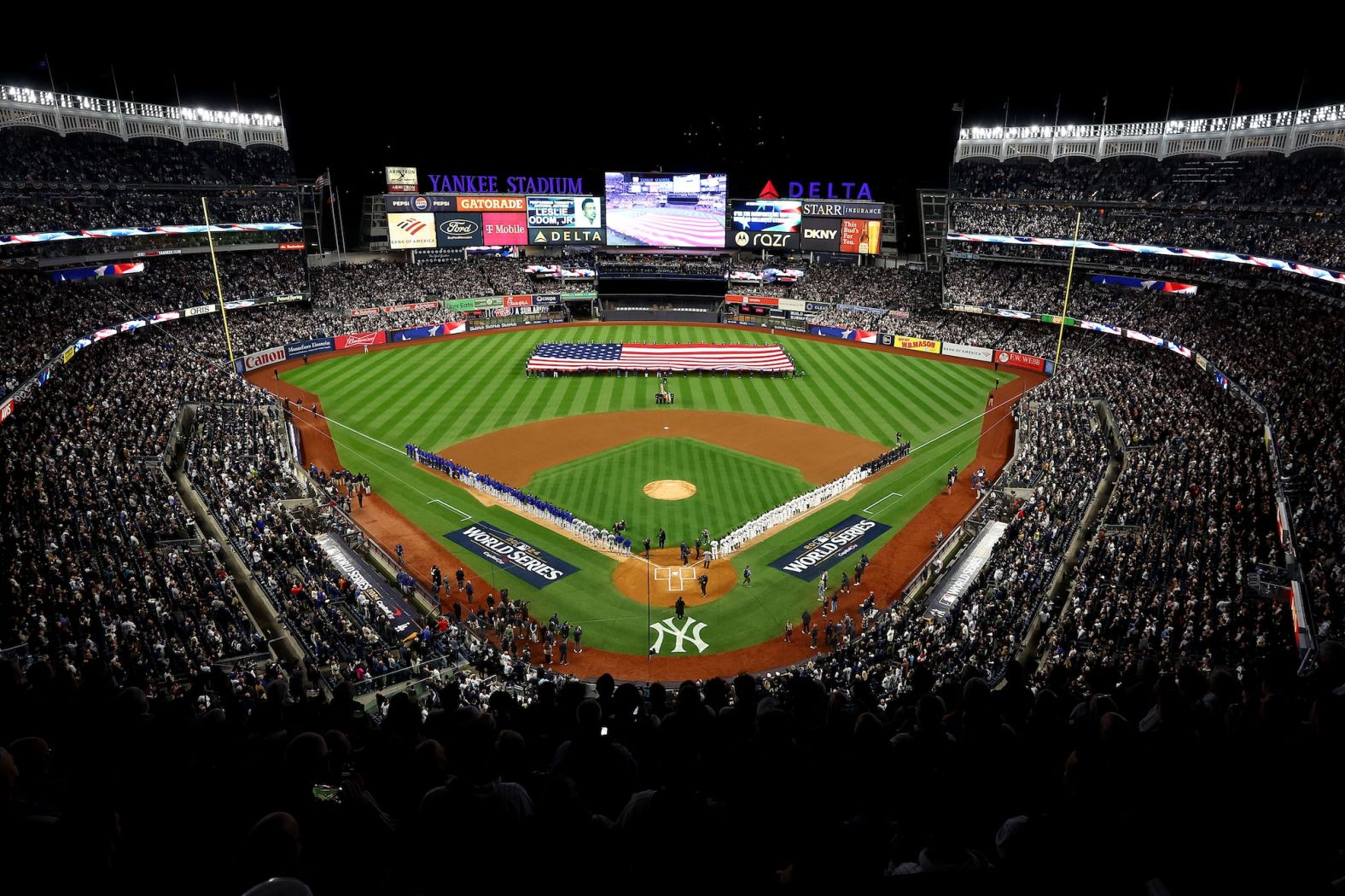 Players line up for the National Anthem before Game 3 at Yankee Stadium.