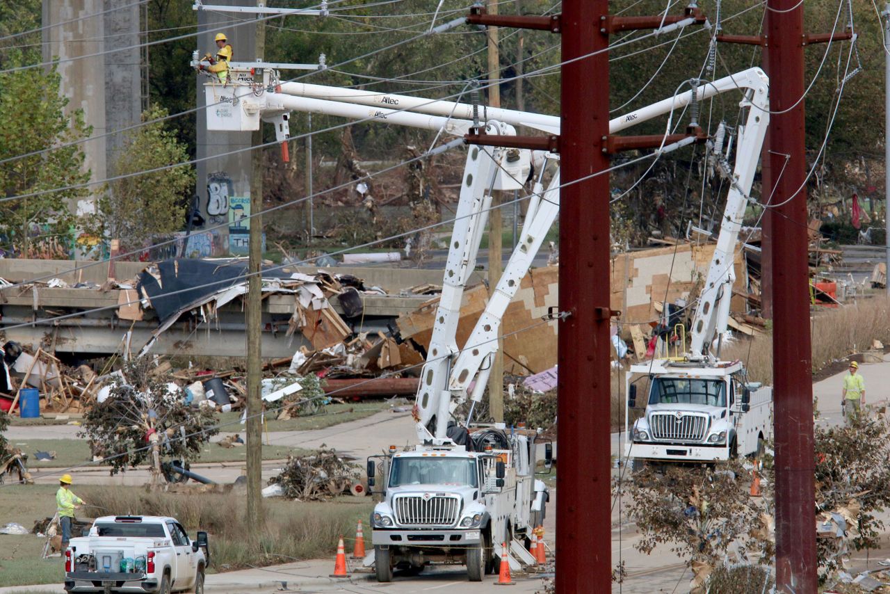 Power crews work in the River Arts District in Asheville, North Carolina, on Tuesday.