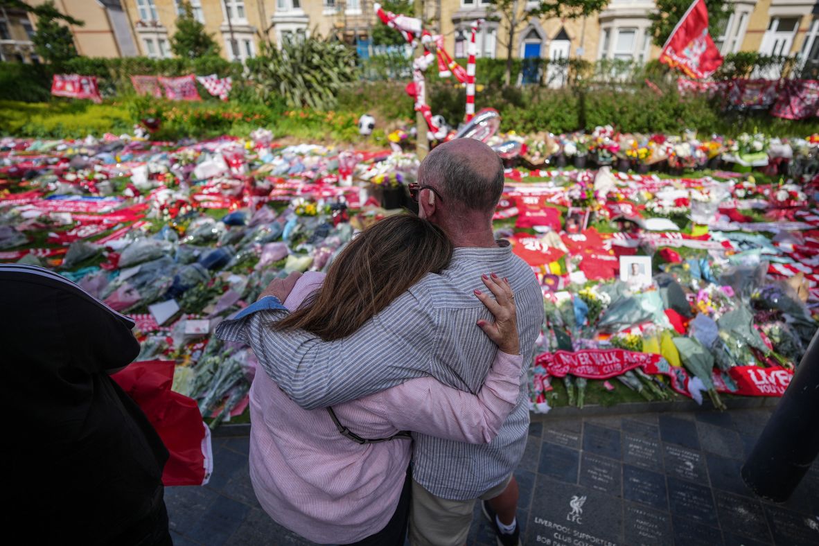 People embrace each other at the Anfield memorial on Friday.