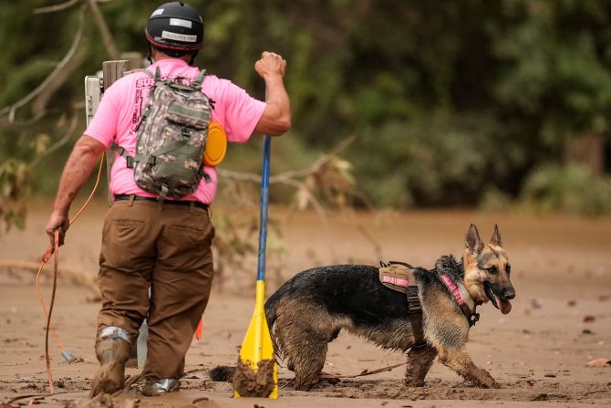 A search-and-rescue team looks for victims in deep mud Tuesday in Swannanoa, North Carolina.