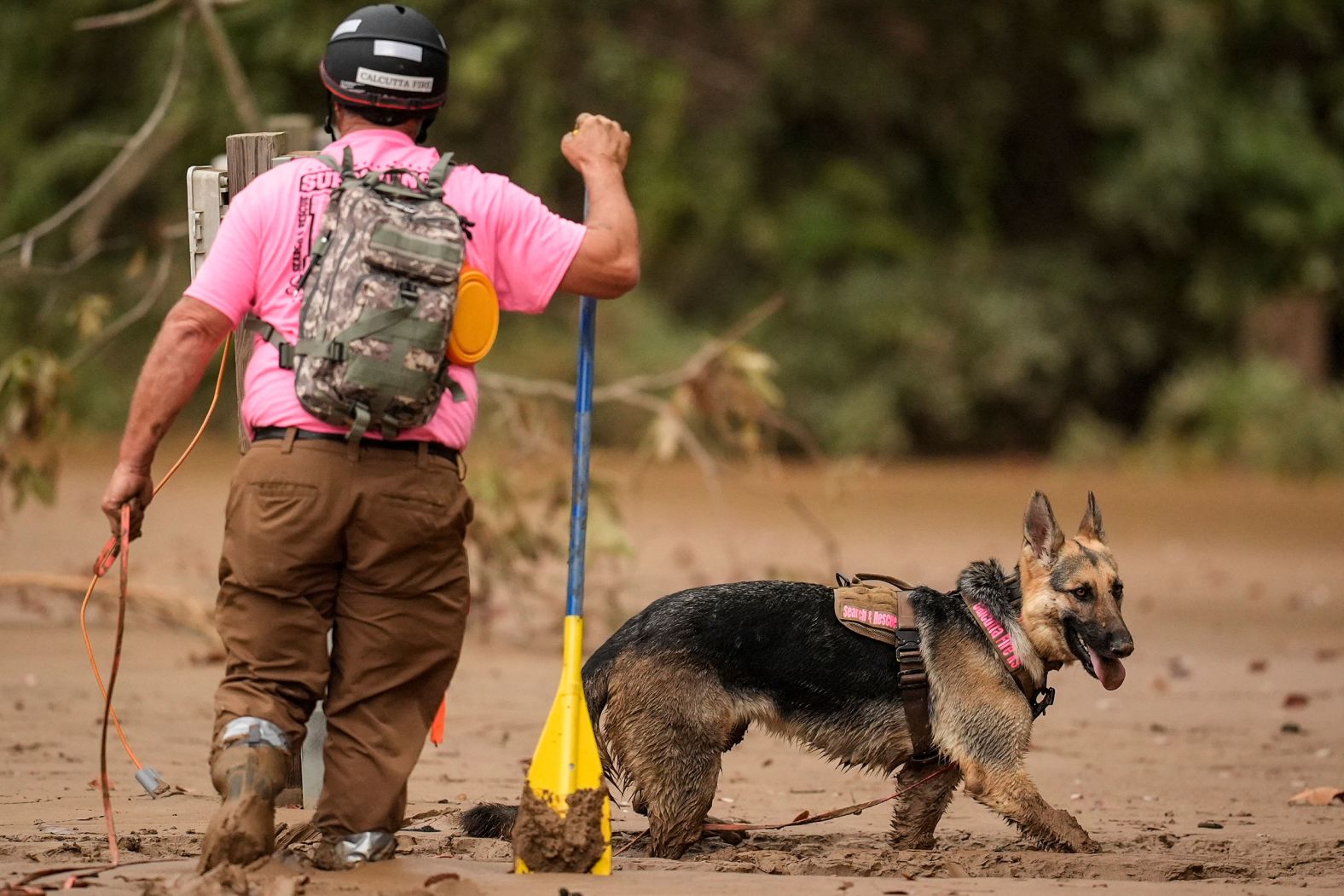 A search-and-rescue team looks for victims in deep mud Tuesday in Swannanoa, North Carolina.