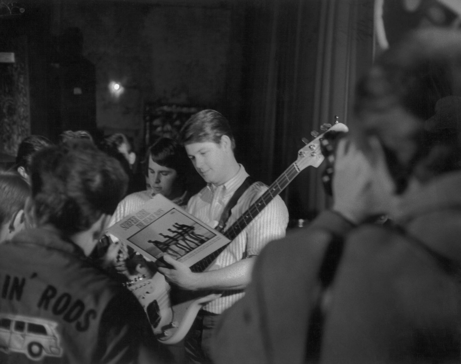 Brian Wilson holds a copy of the Beach Boys' 1963 album "Surfer Girl" in 1964.