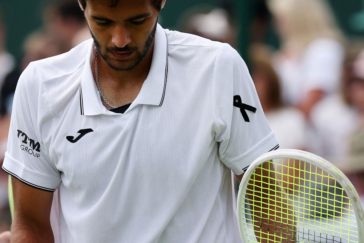 Portuguese tennis player Francisco Cabral wears a black ribbon as a tribute during a doubles match at Wimbledon on Friday.
