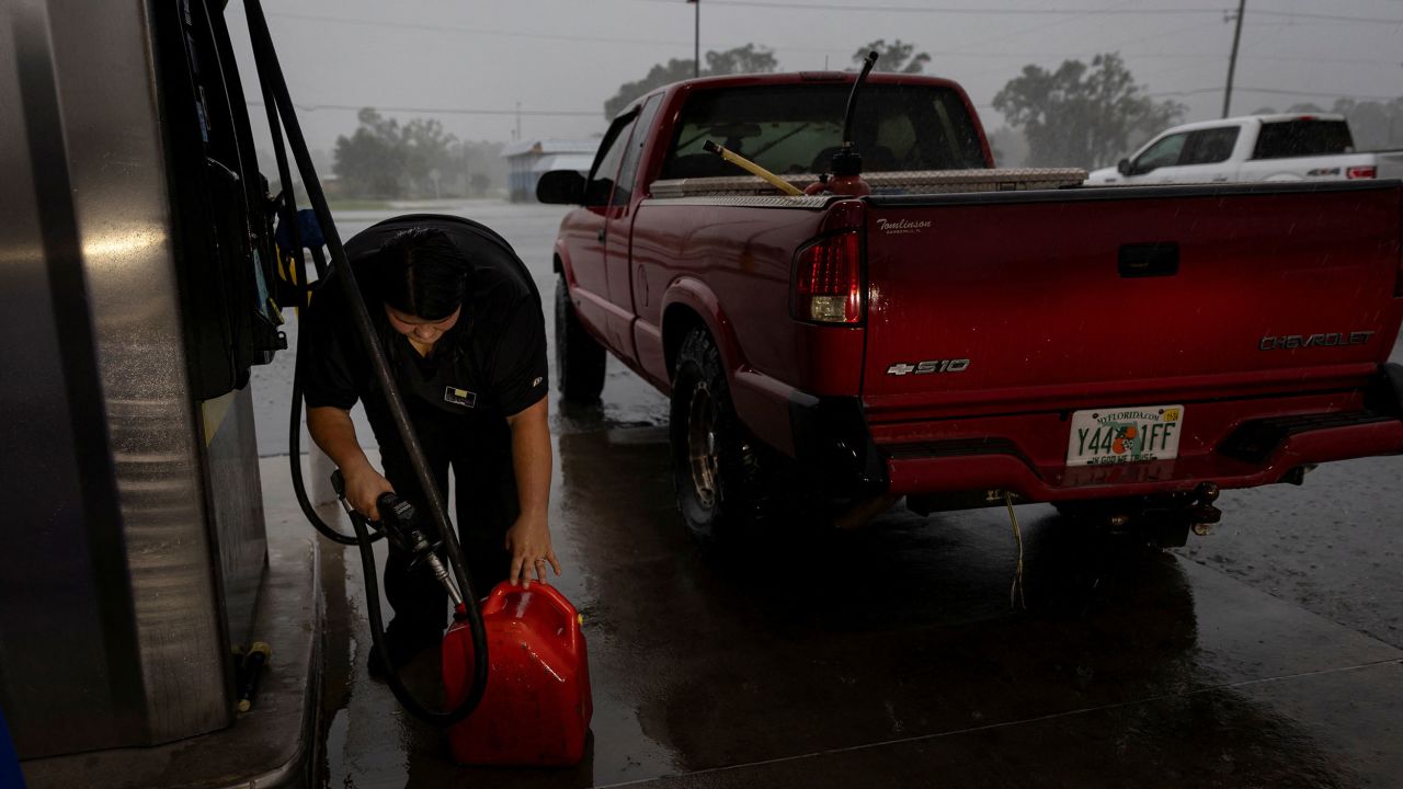 A woman fills up a container with gas ahead of Helene's landfall on Wednesday, September 25, in Cross City, Florida.