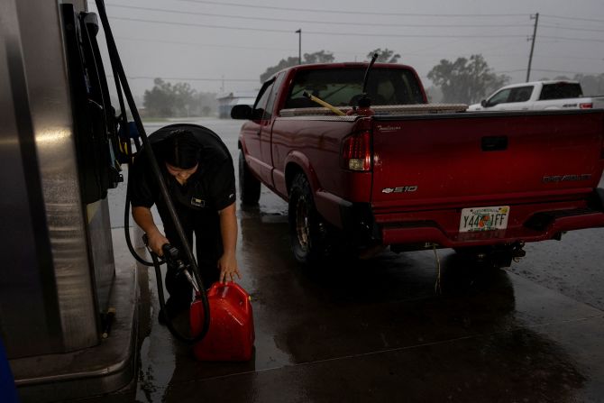 A woman fills up a container with gas ahead of Helene's landfall in Cross City, Florida, on September 25.