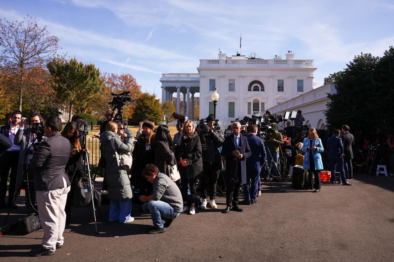 Media members wait outside as President-elect Donald Trump and President Joe Biden meet at the White House in Washington, DC, on November 13.