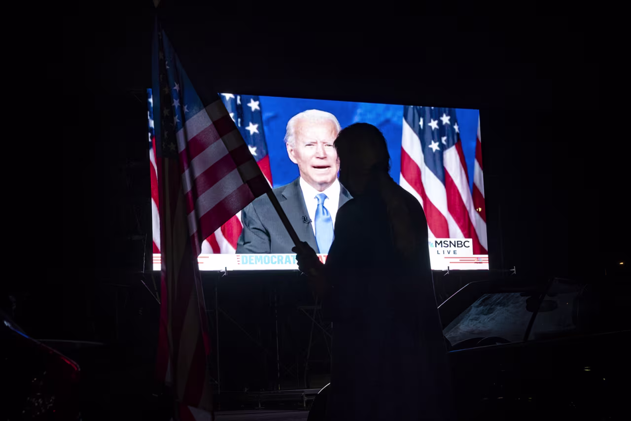 Members of the District of Columbia Democratic Party attend a drive-in watch party in the parking lot of the Robert F. Kennedy Memorial Stadium to watch Democratic presidential nominee Joe Biden accept the Democratic nomination for president on the final night of the Democratic National Convention on August 20 in Washington. 