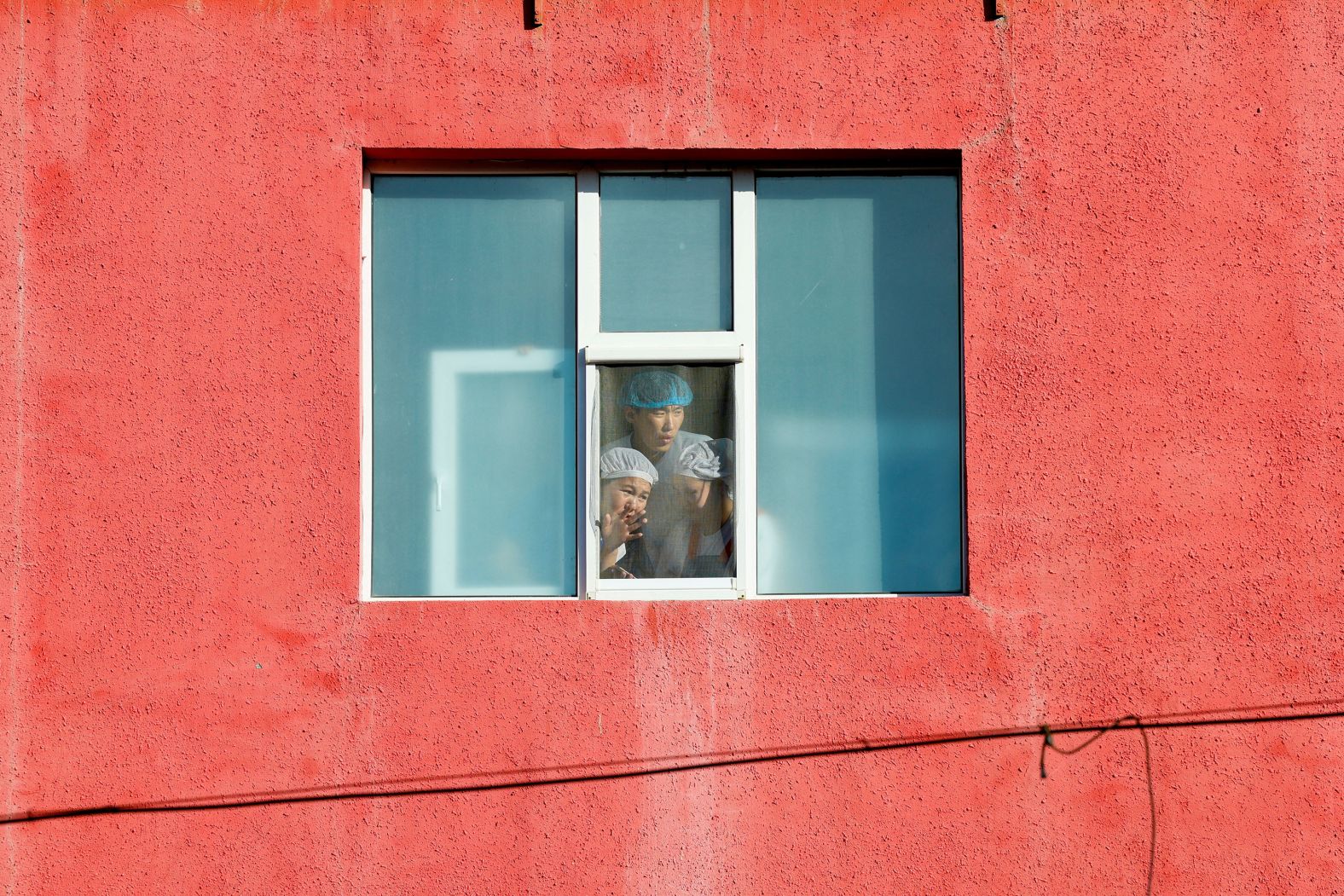 People look out a window in Ulaanbaatar, Mongolia, as they wait for <a href="https://www.cnn.com/2023/09/02/asia/pope-francis-mongolia-trip-intl/index.html">Pope Francis</a> to leave the Saints Peter and Paul Cathedral on Saturday, September 2.