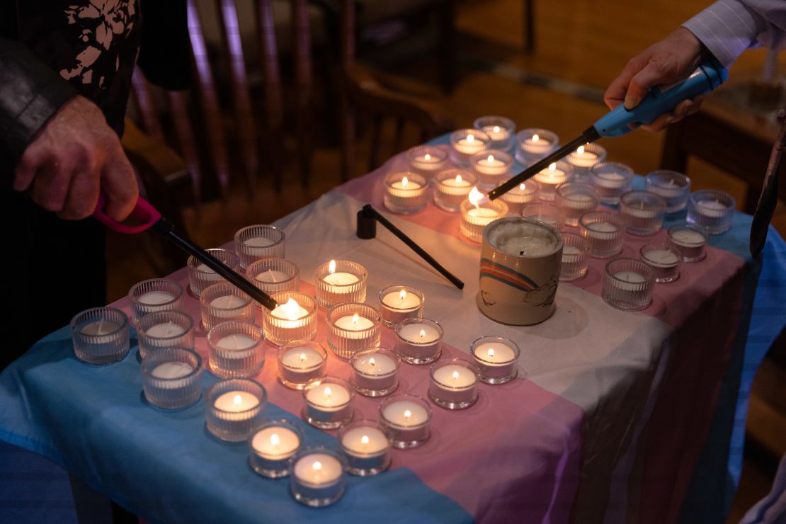 People light candles ahead of the event. Each of the candles were lit – and extinguished – in honor of the trans people killed in the US in the past year. 