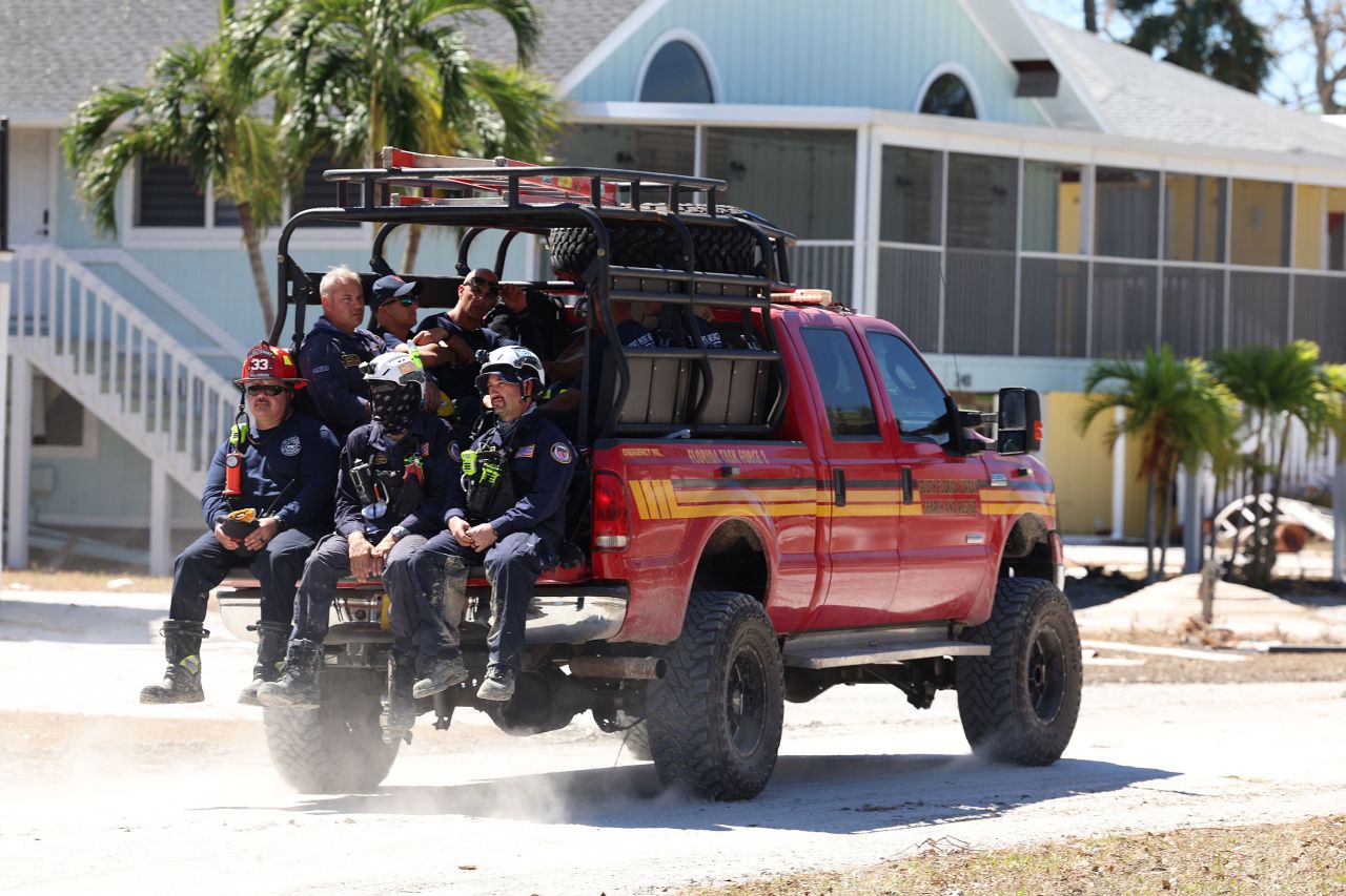 Members of the City of Miami Florida Task Force 2 Search and Rescue team check homes for victims in Fort Myers Beach, Florida, on Monday.