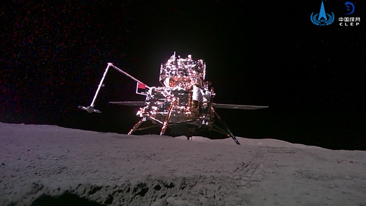 The Chang’e-6 probe is seen raising a Chinese flag with a robotic arm on the moon’s dark side.