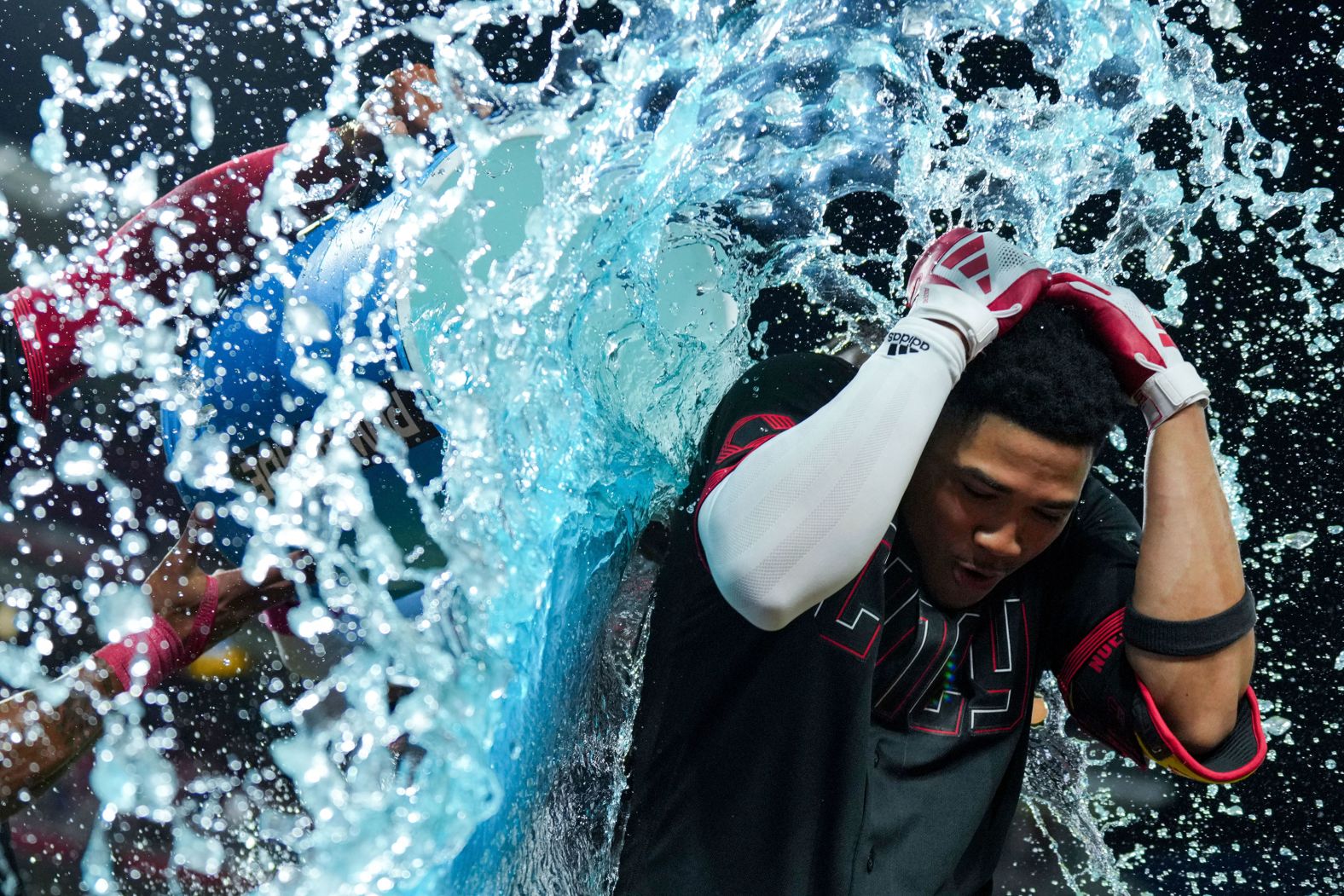 Cincinnati Reds infielder Noelvi Marté is doused by teammate Will Benson after his RBI single won a Major League Baseball game against the Chicago Cubs on Friday, September 1.