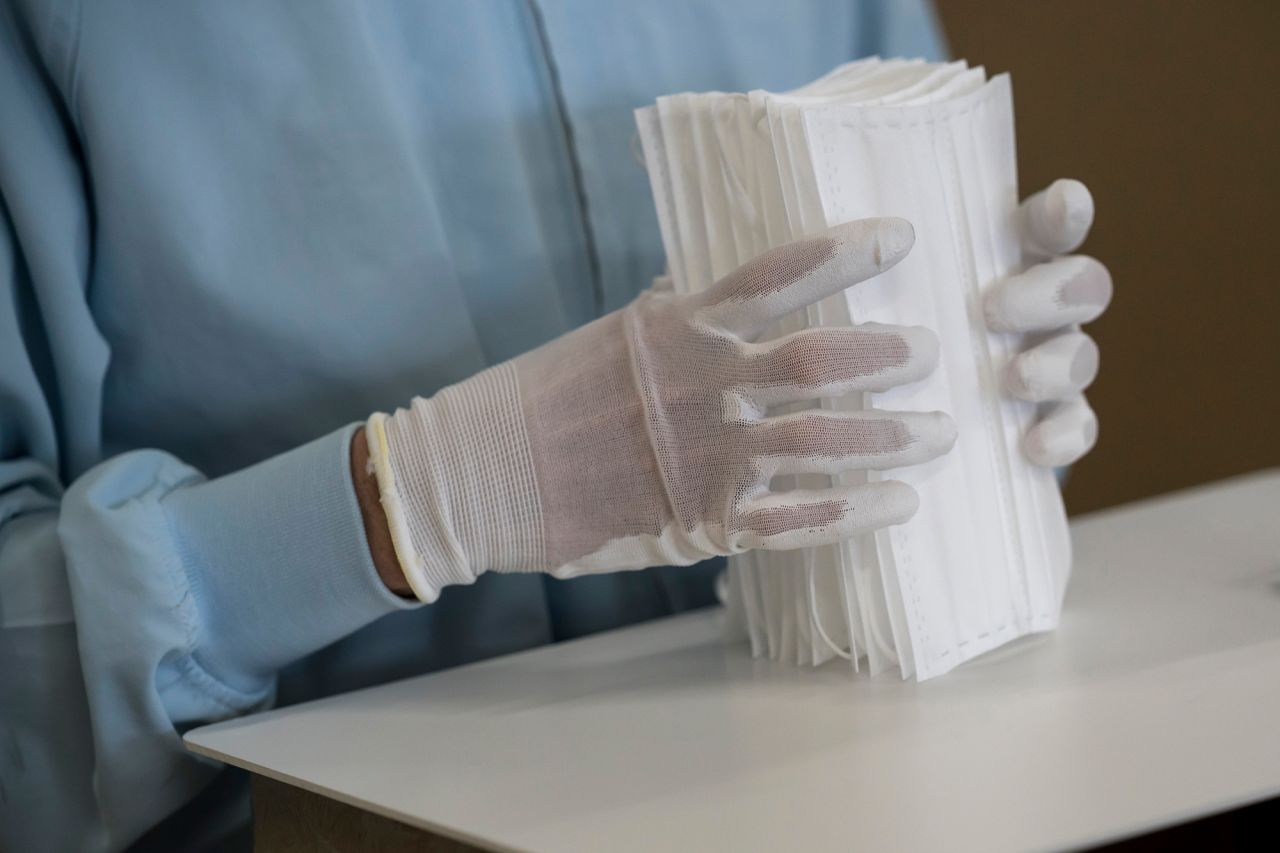 An employee inspects disposable face masks on the production line of the Yokoi Co. Ltd. factory on February 06 in Nagoya, Japan. 