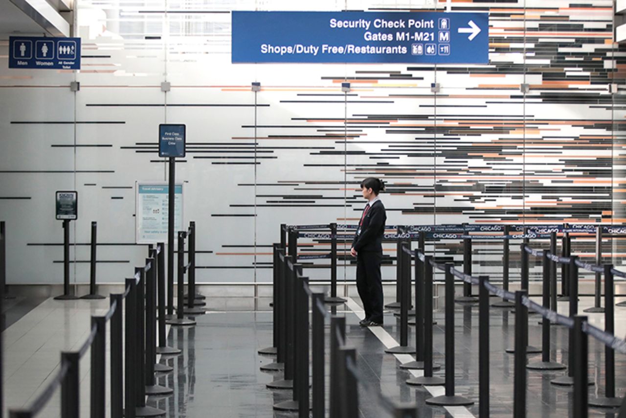  worker staffs a security checkpoint in the international terminal at O'Hare Airport on March 12,  in Chicago, Illinois. 