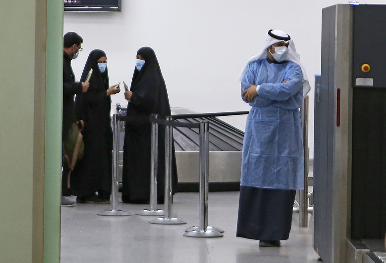 Kuwaitis coming back from Iran wait at Sheikh Saad Airport in Kuwait City on February 22 before being taken to a hospital to be tested for coronavirus. 