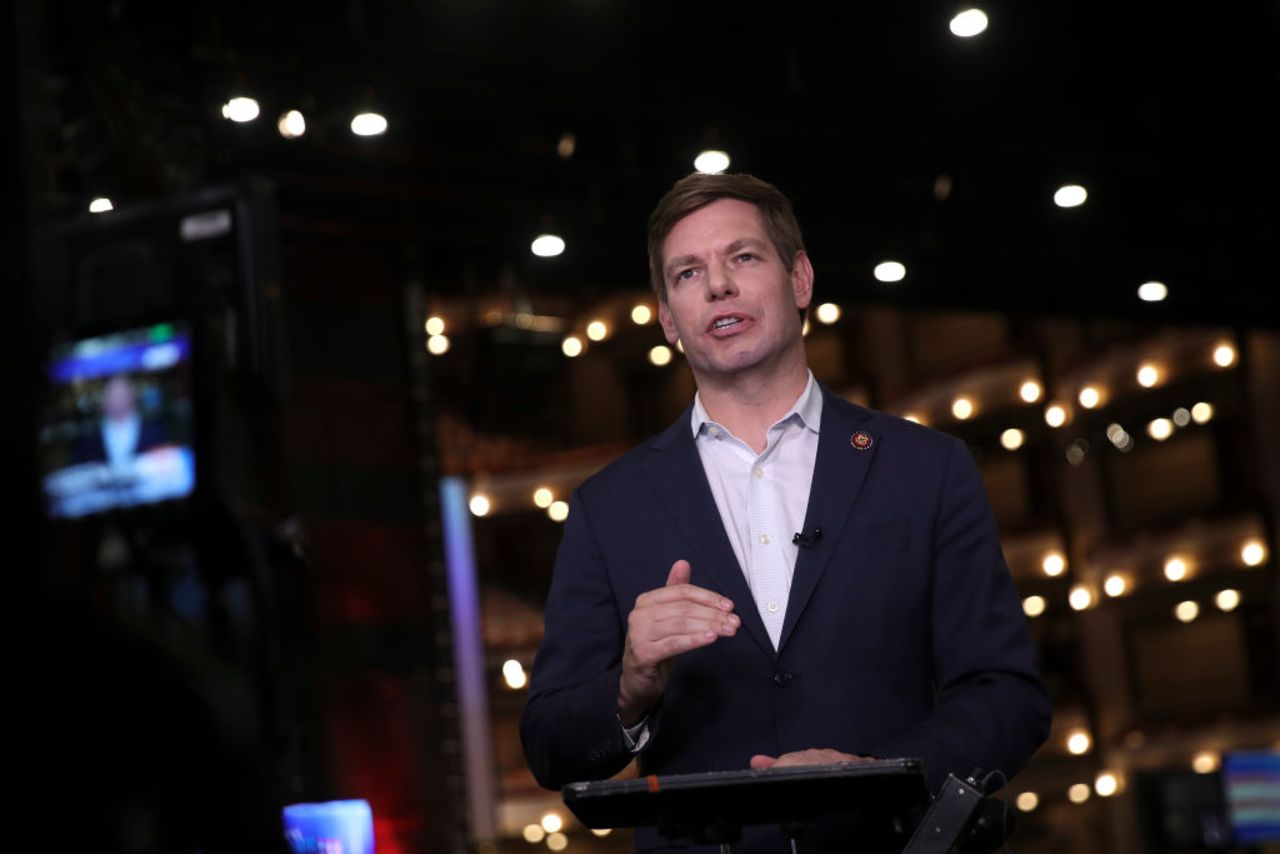 Democratic presidential candidate Rep. Eric Swalwell (D-CA) does a television interview in the spin room before the second night of the first Democratic presidential debate on June 27, 2019 in Miami, Florida. 