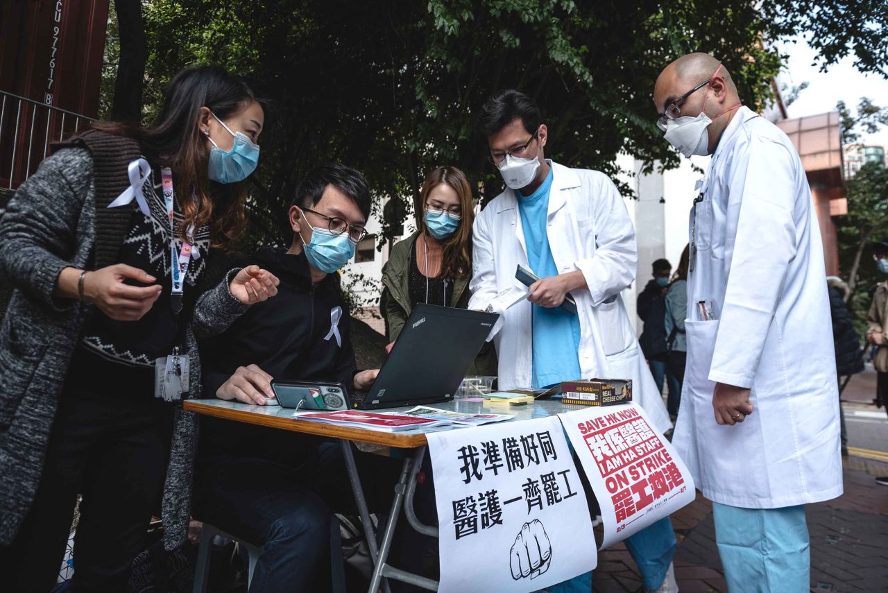 Doctors register for the medical workers strike in support of border closures at the Queen Elizabeth Hospital in Hong Kong on Monday.