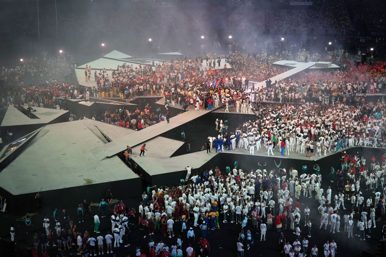 Athletes gather on stage. 