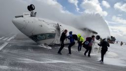 Passengers leave a Delta Air Lines CRJ-900 jet after it crashed on landing at Toronto Pearson International Airport in Mississauga, Ontario, Canada February 17, 2025 in a still image from video.  Peter Koukov/Handout via REUTERS 
THIS IMAGE HAS BEEN SUPPLIED BY A THIRD PARTY