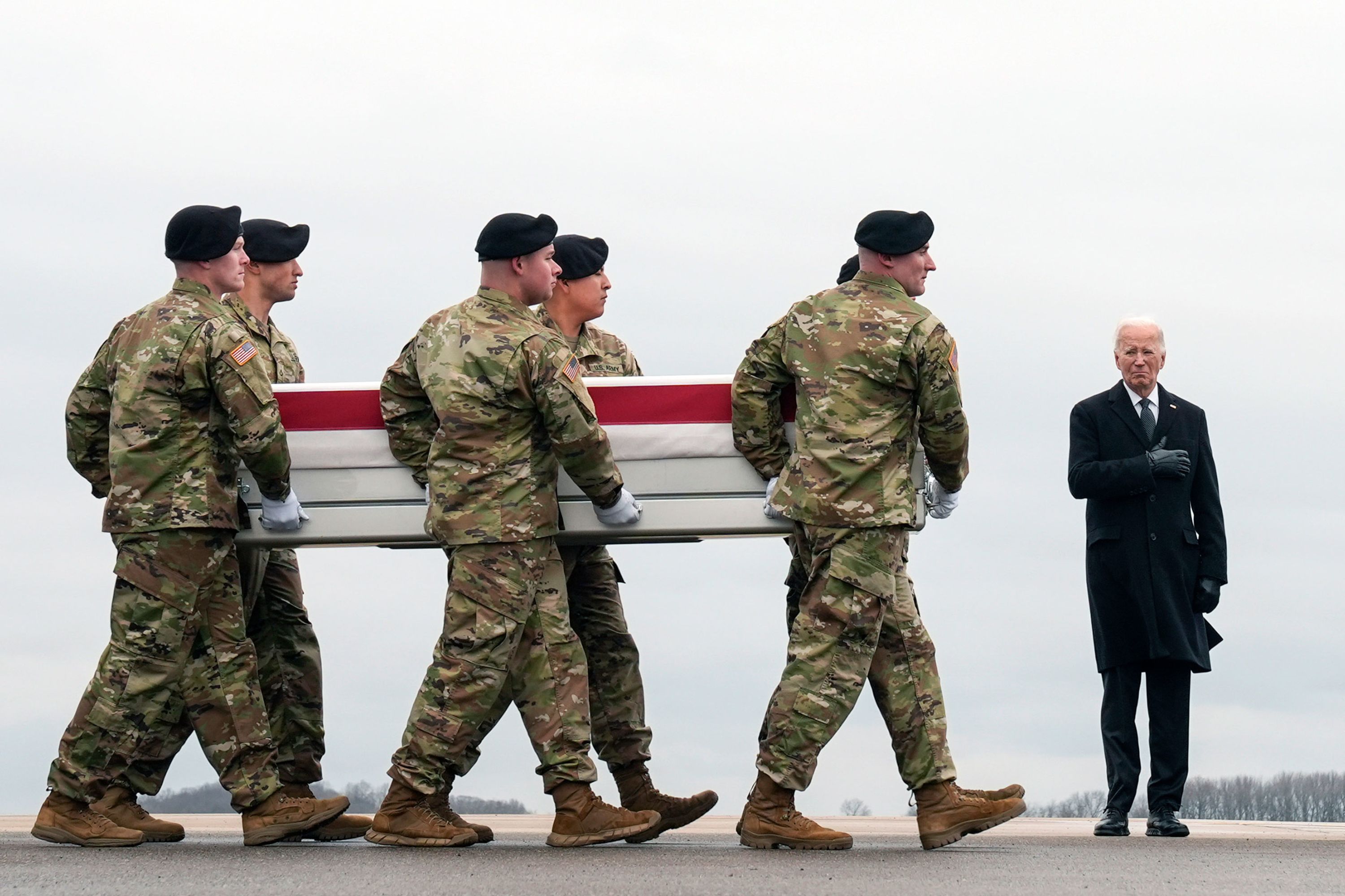 US President Joe Biden stands near an Army carry team holding the transfer case of Sgt. Kennedy Sanders, one of three American soldiers killed in a drone attack in Jordan, on Friday, February 2.