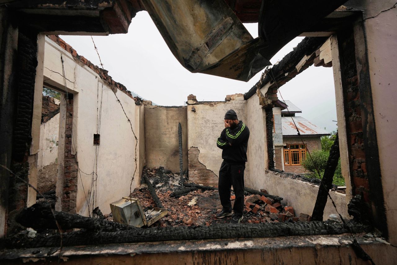 Mohammad Sahil stands inside his house after it was damaged by Pakistani artillery, at Salamabad village in Uri, India-administered Kashmir, on Thursday, May 8.