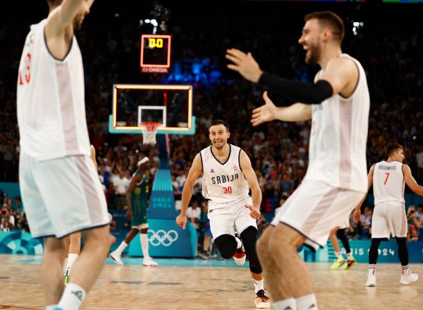 Serbian players celebrate their quarterfinal win over Australia on August 6. <a >They came back from a 24-point deficit</a> to win in overtime.