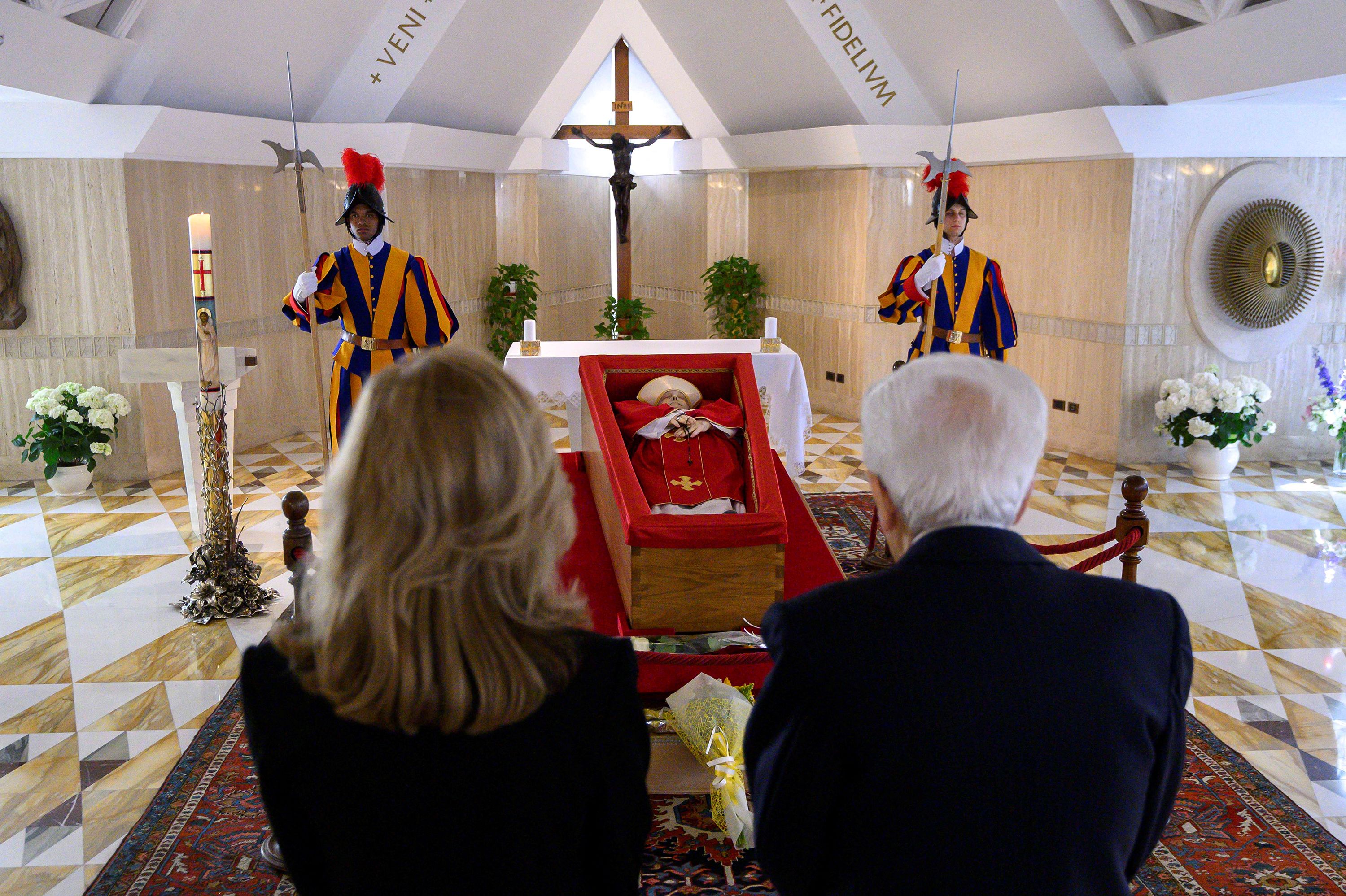 Italian President Sergio Mattarella pays his respects to Pope Francis on Tuesday. Francis was lying in state at the Casa Santa Marta residence, where he lived during his papacy.