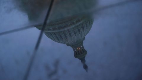 The US Capitol dome is reflected in a puddle on the ground, on September 29, 2025.