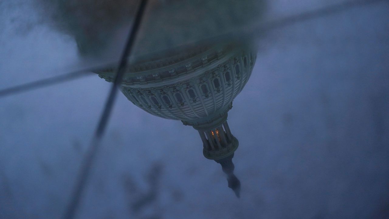 The US Capitol dome is reflected in a puddle on the ground, on September 29, 2025.