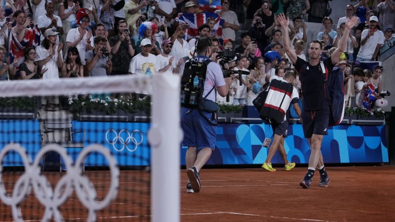 Andy Murray of Britain waves to the spectators as he and his partner Daniel Evans leave the court after defeated by Taylor Fritz and Tommy Paul of the United States in the men's doubles quarterfinals tennis match, at the 2024 Summer Olympics, Thursday, Aug.1, 2024, at the Roland Garros stadium in Paris, France. (AP Photo/Andy Wong)