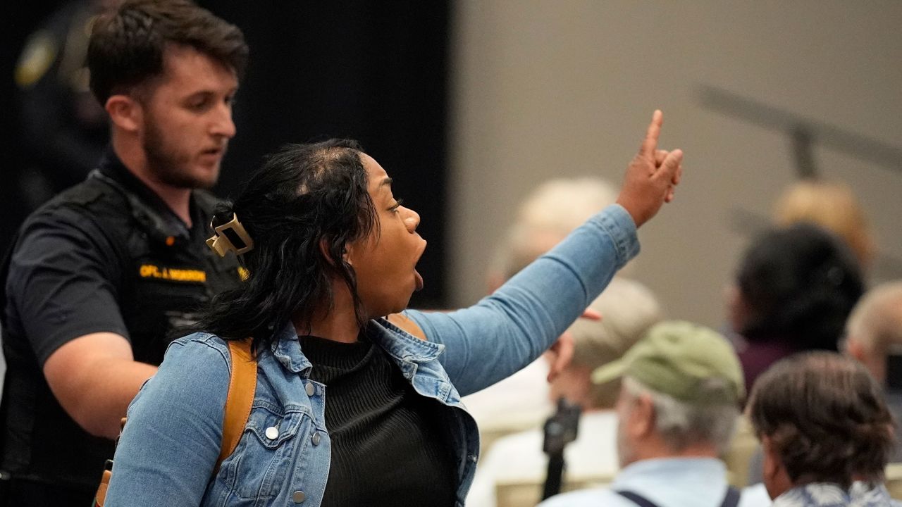 A protester is removed from an event with Rep. Marjorie Taylor Greene in Acworth, Georgia, on Tuesday.