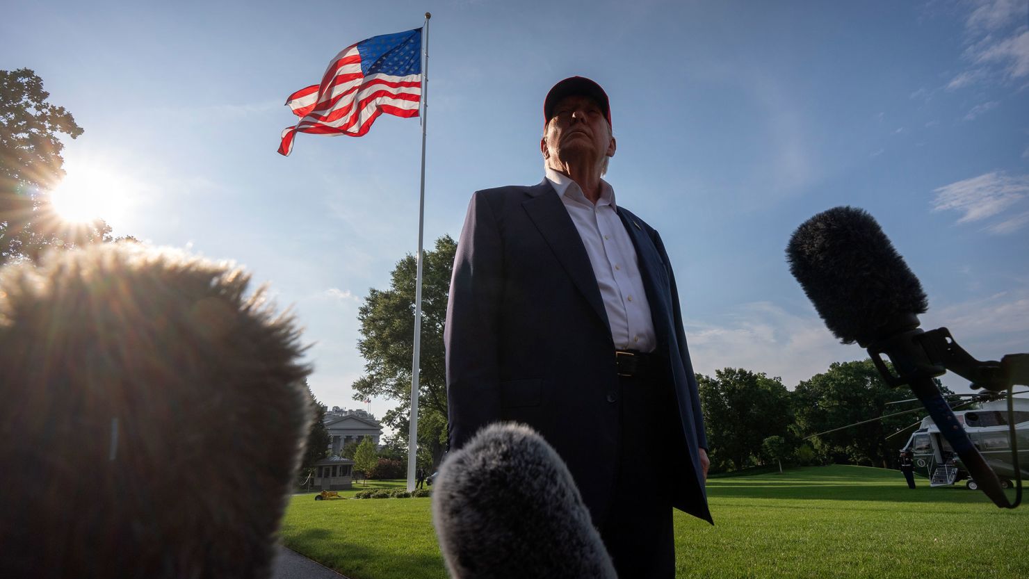 President Donald Trump speaks to the media before walking across the South Lawn of the White House on Tuesday.