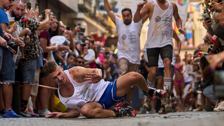 A participant falls wearing shoes with heels of at least 15 centimeters (5.9 inches) as they compete in the annual high heel race during Madrid's Pride week in Madrid, Spain, Thursday, July 3, 2025. (AP Photo/Manu Fernandez)
