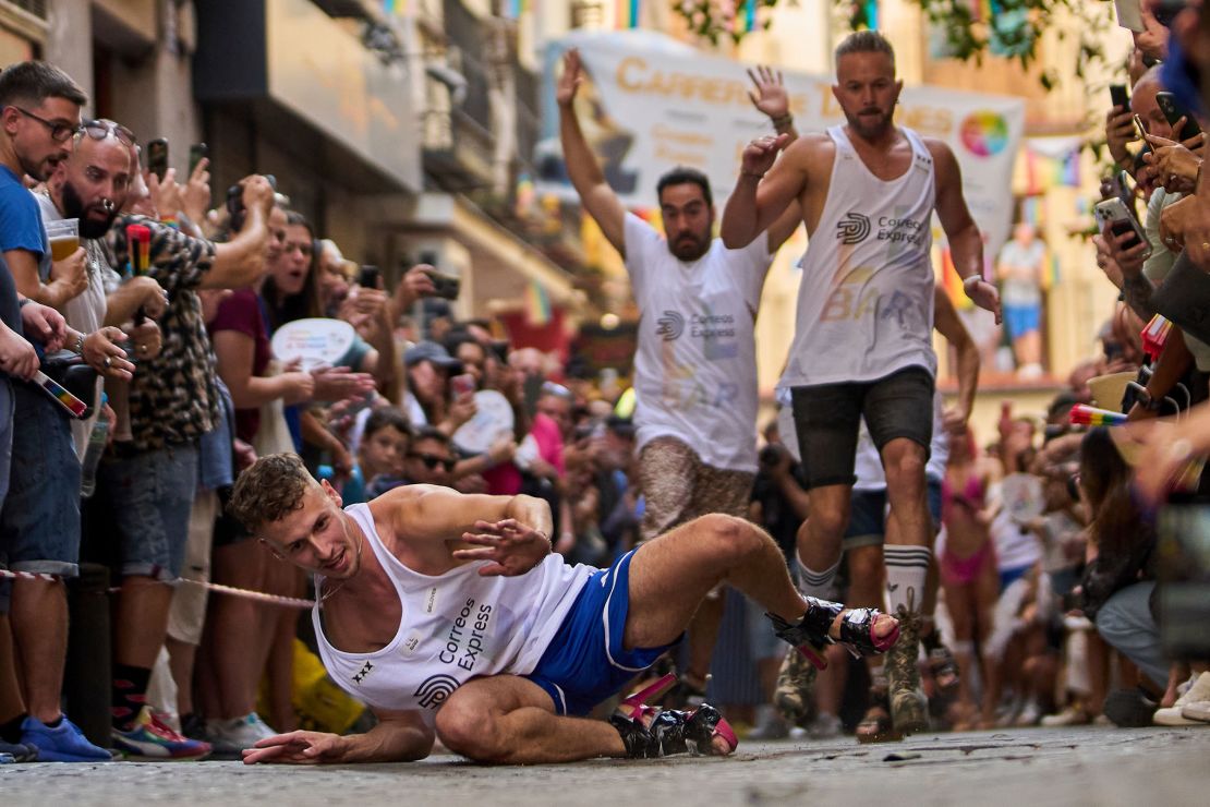 A runner falls as they compete in the race. Participants have to wear shoes with heels of at least 10 centimeters (5.9 inches).