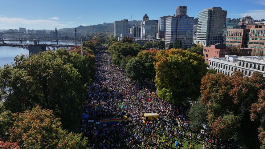 People gather along a waterfront park in Portland, Oregon, during a "No Kings" protest on Saturday.