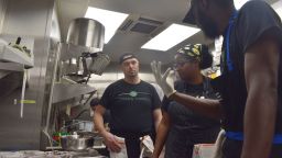 Chef Ashley Fils-Aime, Vicheslav Komotopchyk and Vicheslav Komotopchyk discuss the brownies.