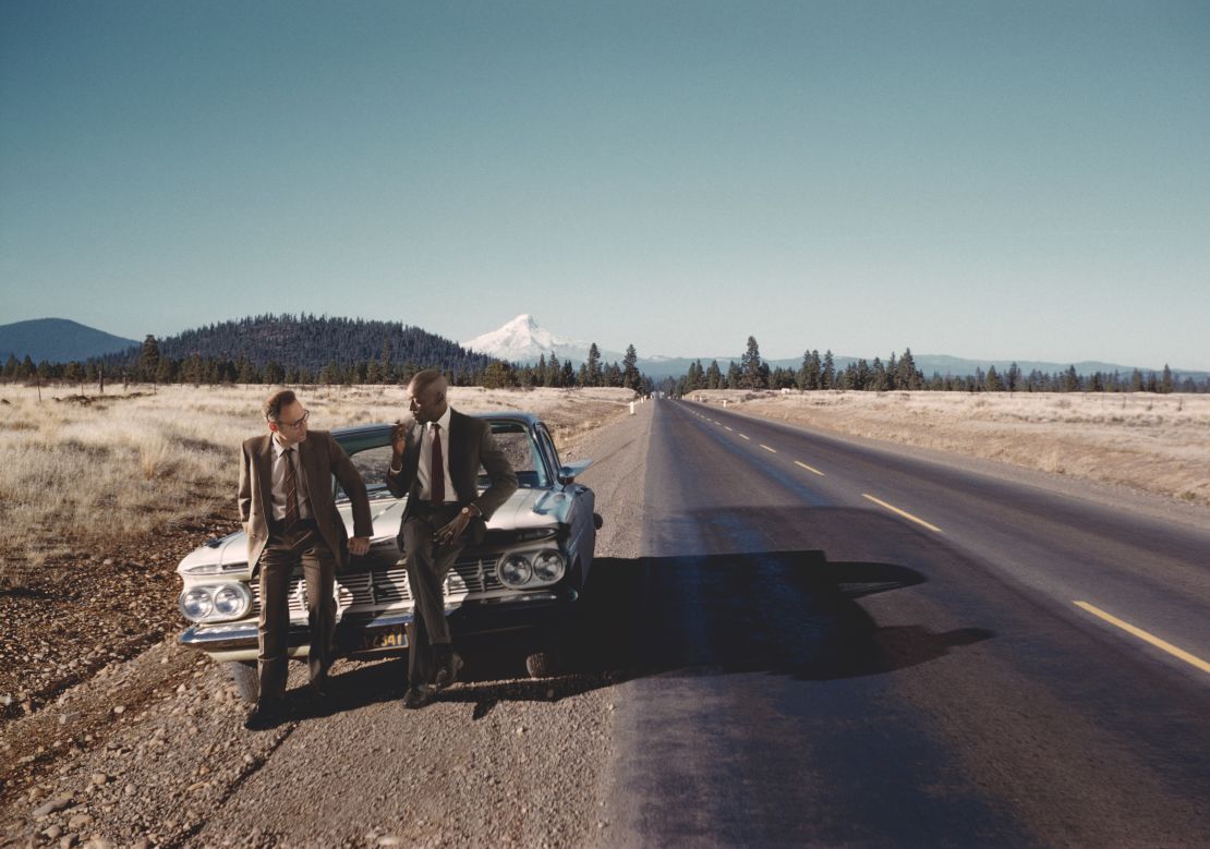 Omar Victor Diop (right) and Lee Shulman (left) feature together in one image, taken of a car with Mt. Hood in the background.