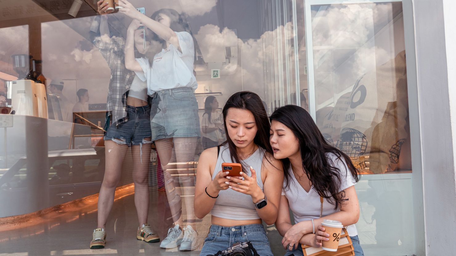 Chinese tourists in Hong Kong's Kennedy Town district take pictures at a cafe that has become incredibly popular thanks to the Xiaohongshu social media app.