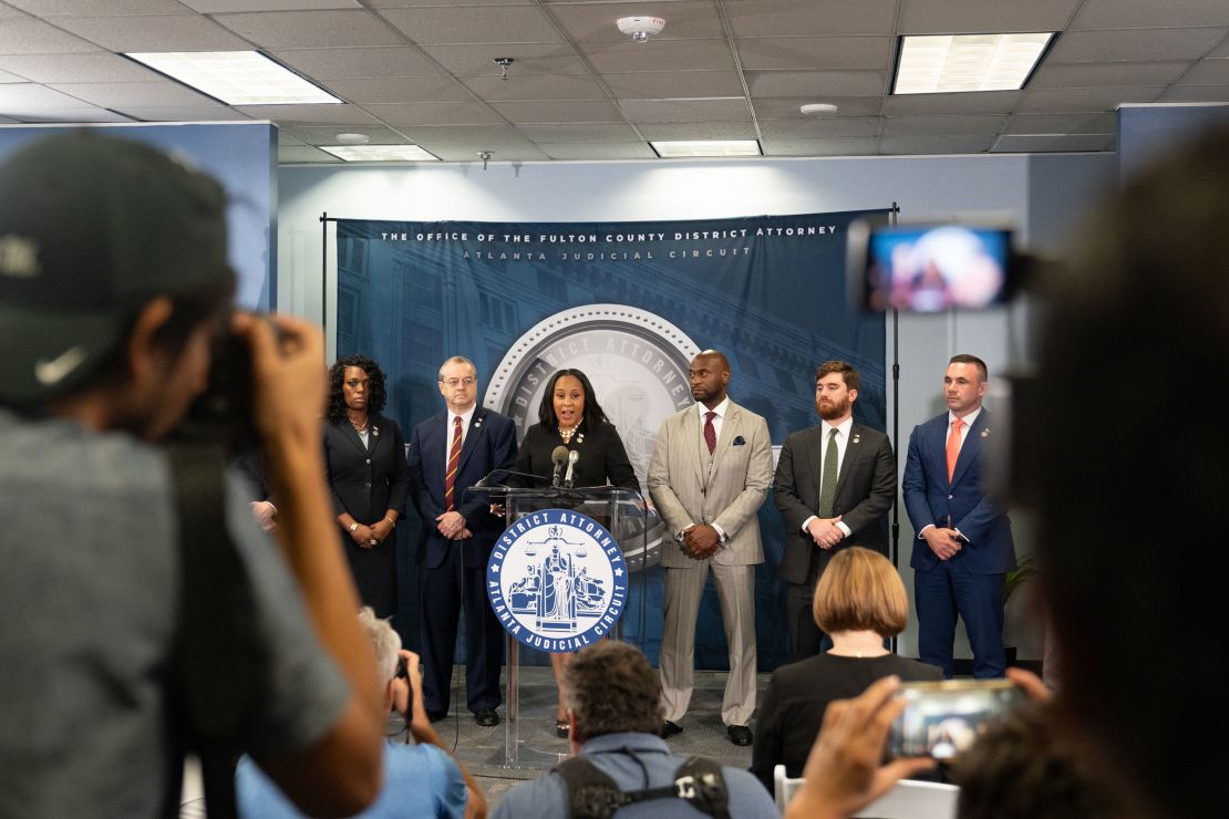 Fulton County District Attorney Fani Willis, flanked by Wade on her left, speaks at a news conference on August 14, 2023 in Atlanta, Georgia.