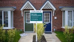 A for sale sign is seen outside new houses on a construction development in June 2023 in Nantwich, England.