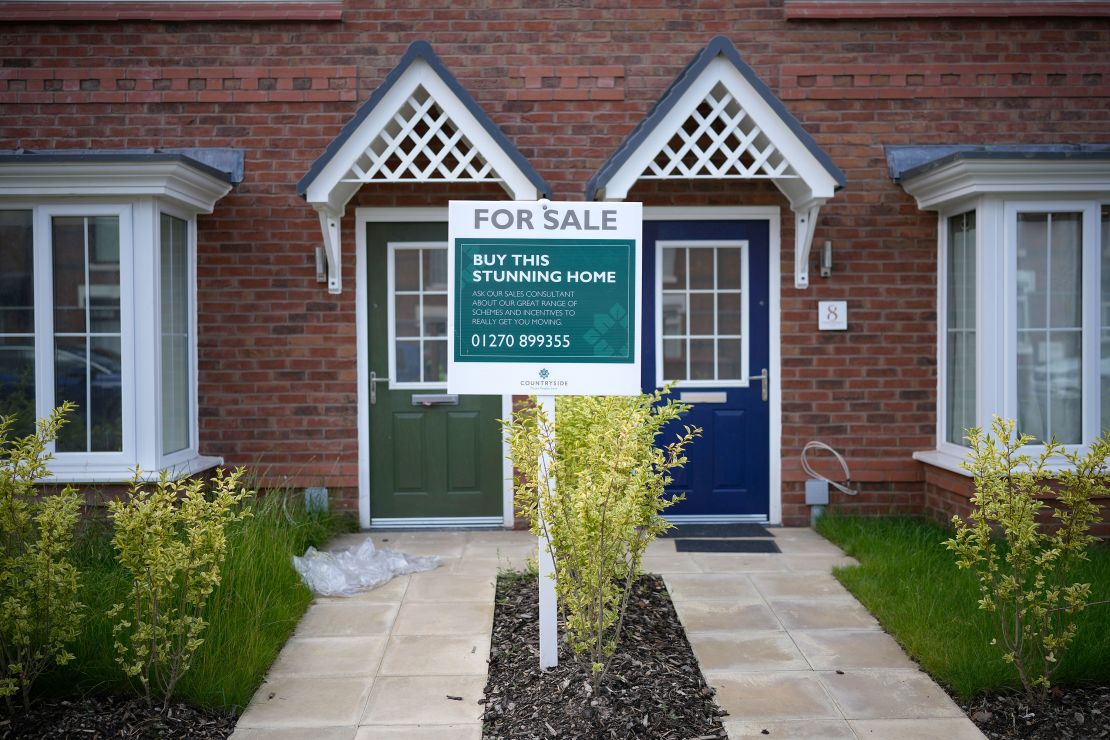 A "for sale" sign outside houses on a construction development in Nantwich, England, seen in June 2023.