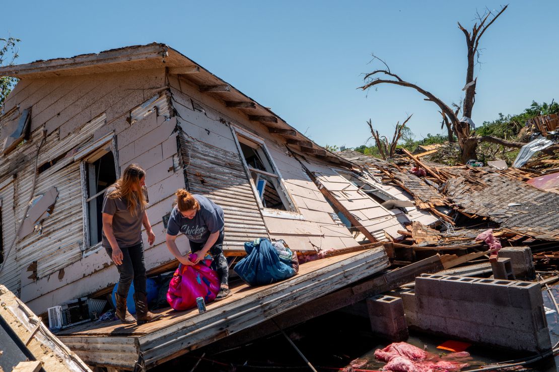 The Crowder family sift through and recover lost items after their home was struck by a tornado on May 07, 2024 in Barnsdall, Oklahoma.