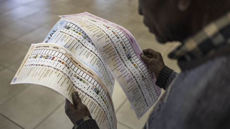 An early voter checks his ballot papers at the Yeoville Recreation Centre in Johannesburg on May 27, 2024.