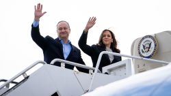 US Vice President and Democratic presidential candidate Kamala Harris and Second Gentleman Doug Emhoff wave as they board Air Force 2 at Delaware Air National Guard base in New Castle, Delaware, on July 22, 2024. Harris on Monday compared her election rival Donald Trump to "predators" and "cheaters," as she attacked the first former US leader to be convicted of a crime. (Photo by Erin SCHAFF / POOL / AFP) (Photo by ERIN SCHAFF/POOL/AFP via Getty Images)