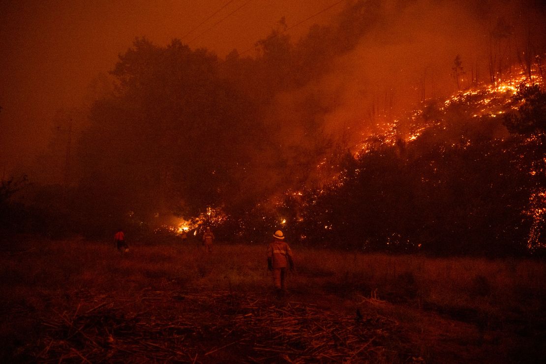 Firefighters try to extinguish a wildfire in Albergaria-a-Velha on September 16.