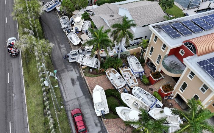 Boats displaced by Hurricane Helene sit in front of homes in Treasure Island, Florida, on Saturday, September 28.