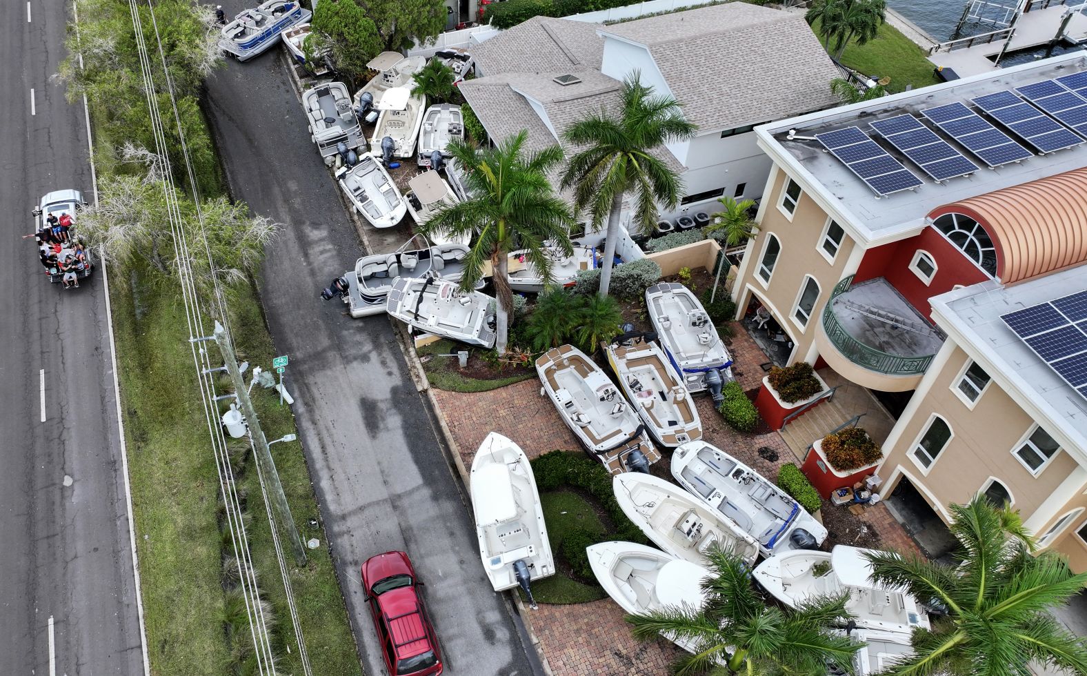 Boats displaced by Hurricane Helene sit in front of homes in Treasure Island, Florida, on Saturday.