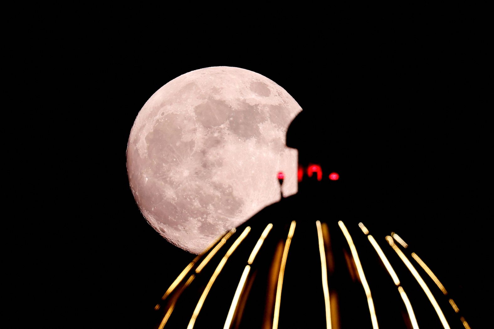 The moon rises behind the dome of a mosque in Doha, Qatar, on Wednesday.